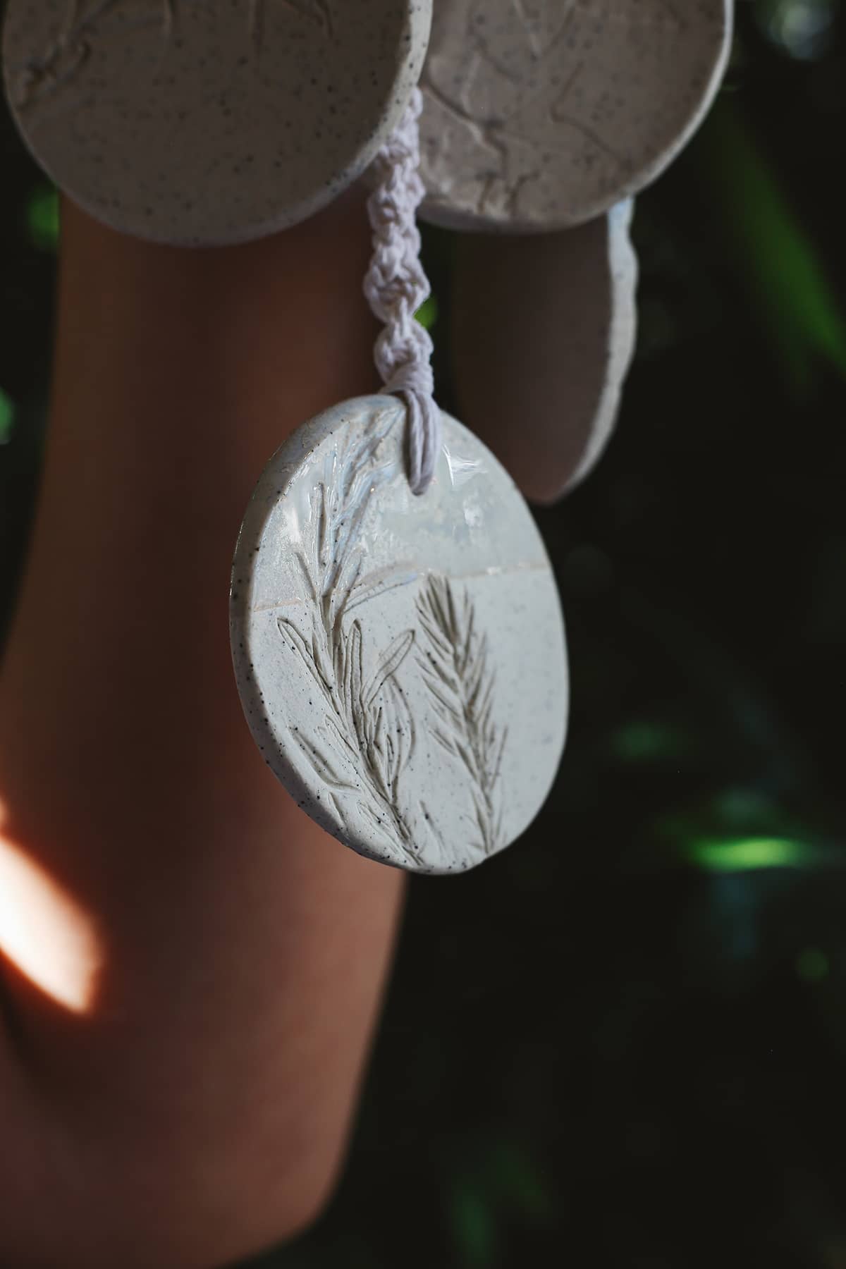 Àine & Co. Handmade Ceramic Car Diffusers in botanical disk style featuring woven string