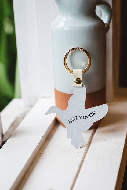 Back of Àine & Co. Ark Colour Design Keyring in "Duck", featuring leather duck design and gold hardware with text "Holy Duck"