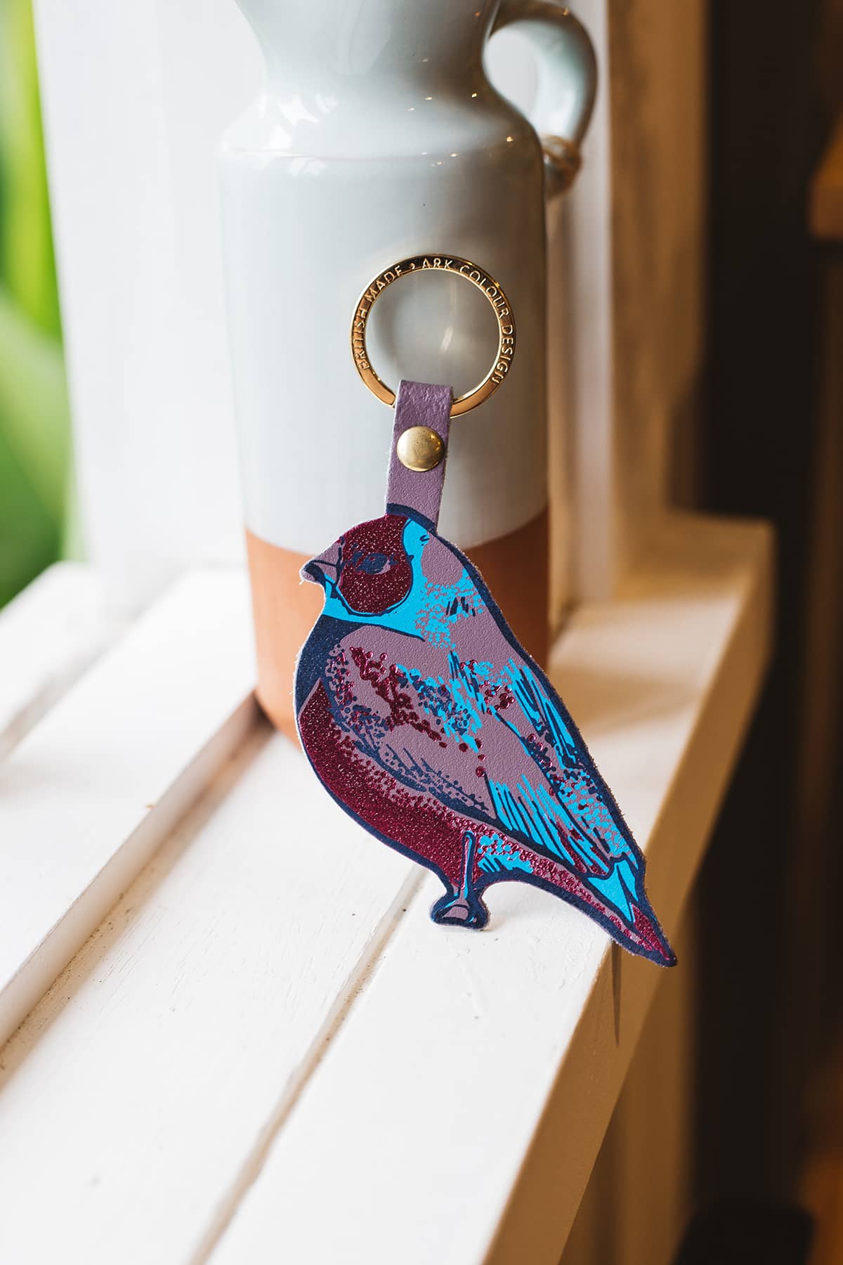 Àine & Co. Ark Colour Design Keyring in "Bird", featuring leather bird design in blue, mauve and red, with gold hardware