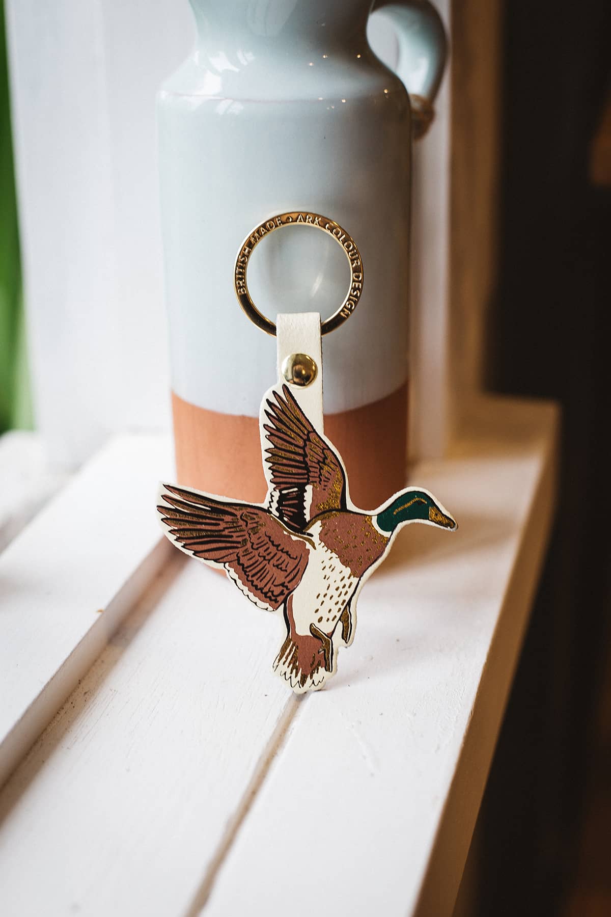 Àine & Co. Ark Colour Design Keyring in "Duck", featuring leather duck design and gold hardware