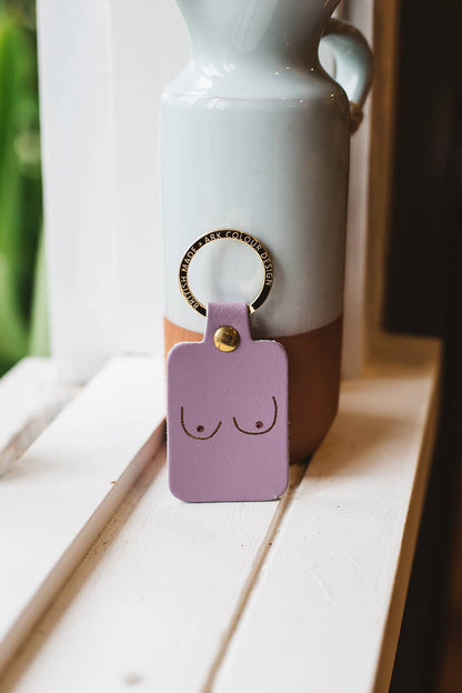 Àine & Co. Ark Colour Design Keyring in "Female (Purple)", featuring leather with illustrated breast design and gold hardware