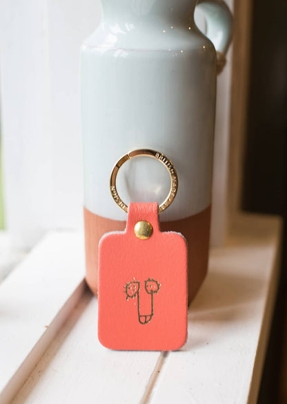 Àine & Co. Ark Colour Design Keyring in "Male (Coral)", featuring leather with illustrated penis design and gold hardware