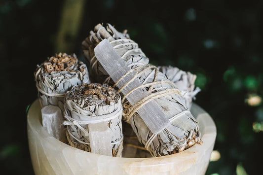 Close-up shot of Àine & Co.'s Selenite & White Sage Cleansing Sticks in a crystal bowl