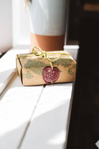 Àine & Co. small wax melt box in 104, packaged in illustrated paper box, wrapped in string, sealed with maroon logo wax seal