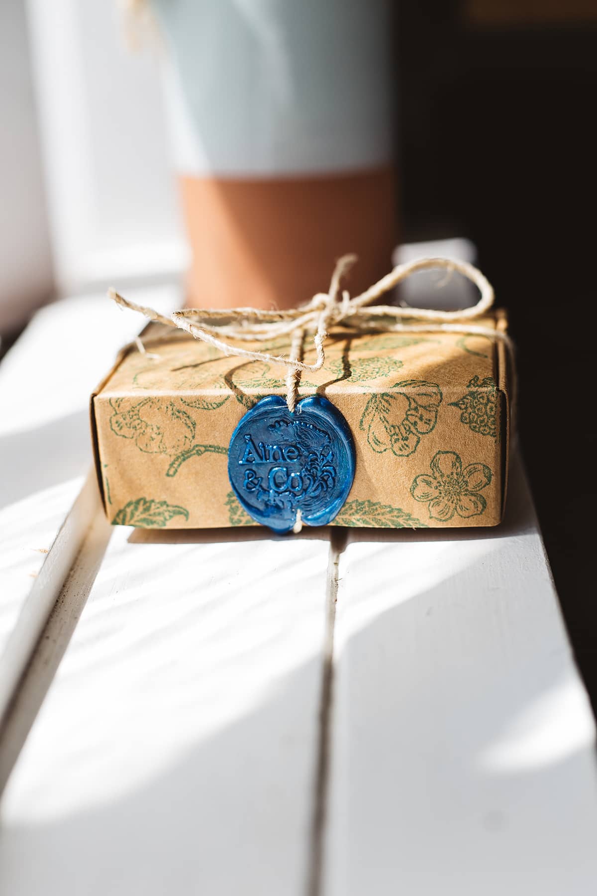 Àine & Co. small wax melt box in Abhaile, packaged in illustrated paper box, wrapped in string, sealed with cobalt logo wax seal