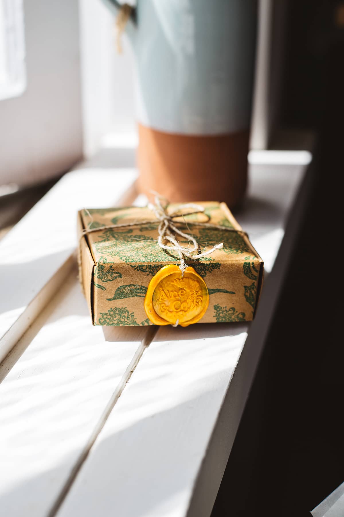 Àine & Co. small wax melt box in Samhain, packaged in illustrated paper box, wrapped in string, sealed with yellow logo wax seal