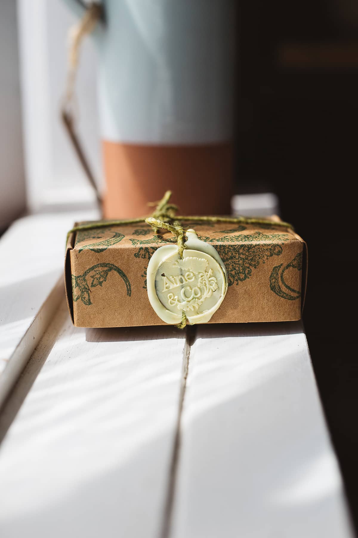 Àine & Co. small wax melt box in Sasta, packaged in illustrated paper box, wrapped in string, sealed with pastel yellow logo wax seal